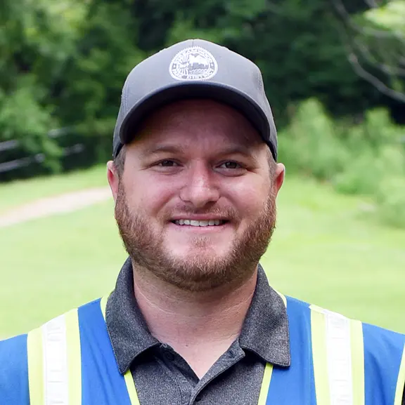 a person wearing a hat and vest