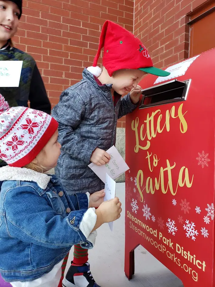 a group of kids looking at a letter box