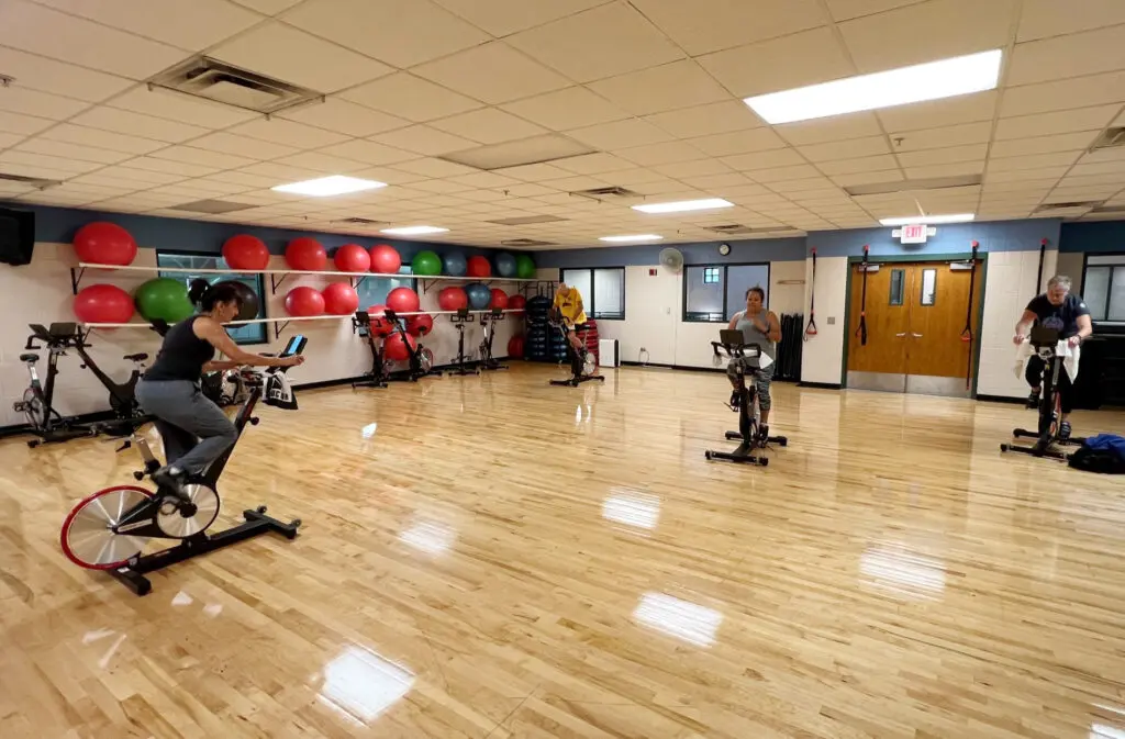 a group of people on exercise bikes in a gym