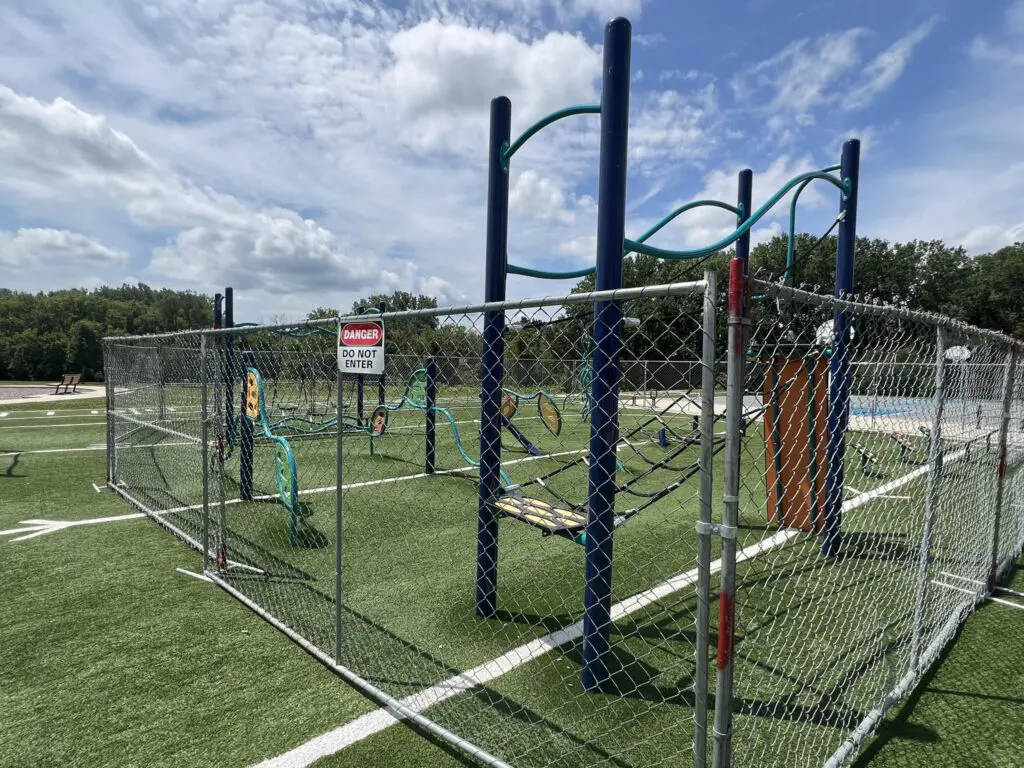 a playground with a chain link fence