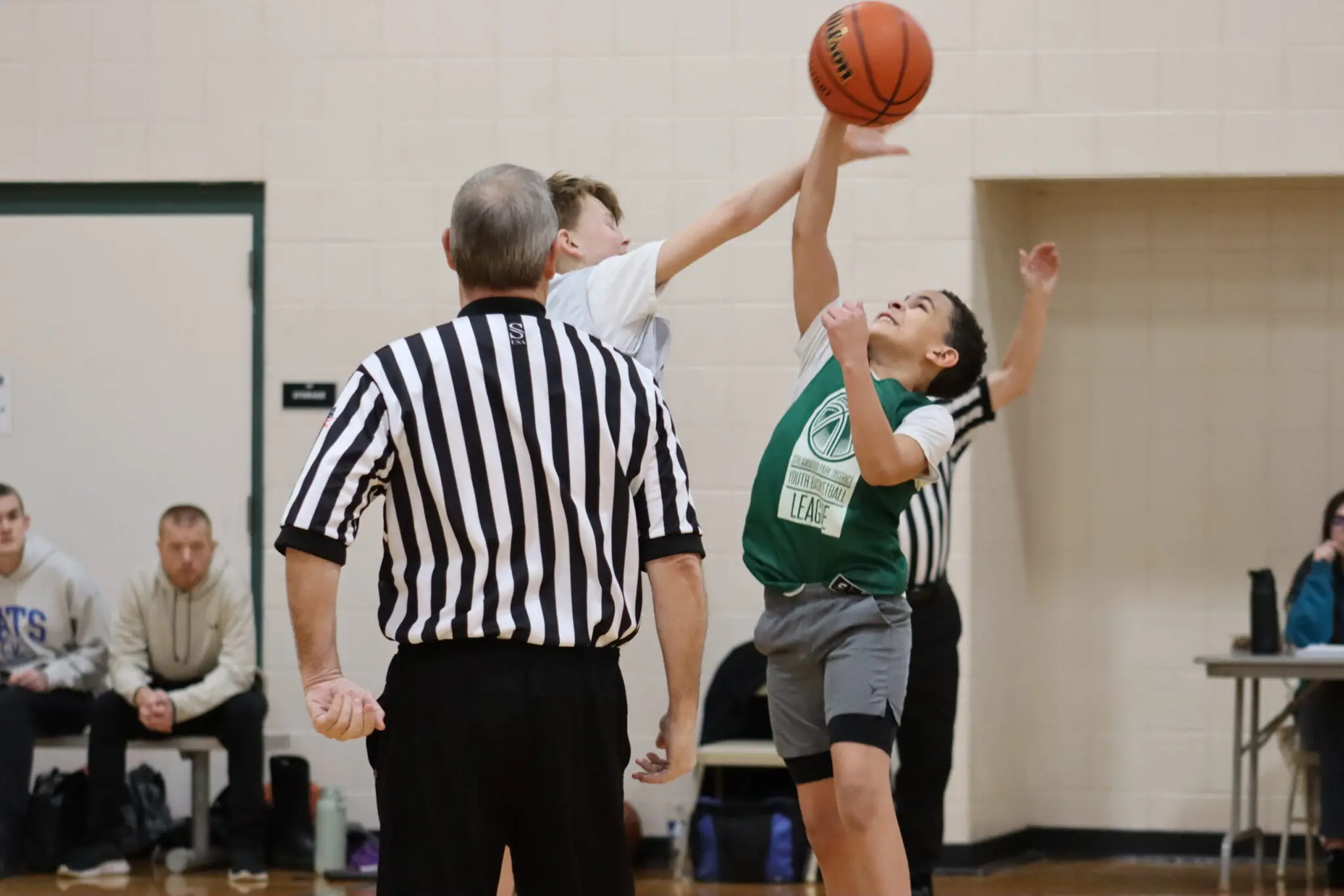 a child reaching for a basketball