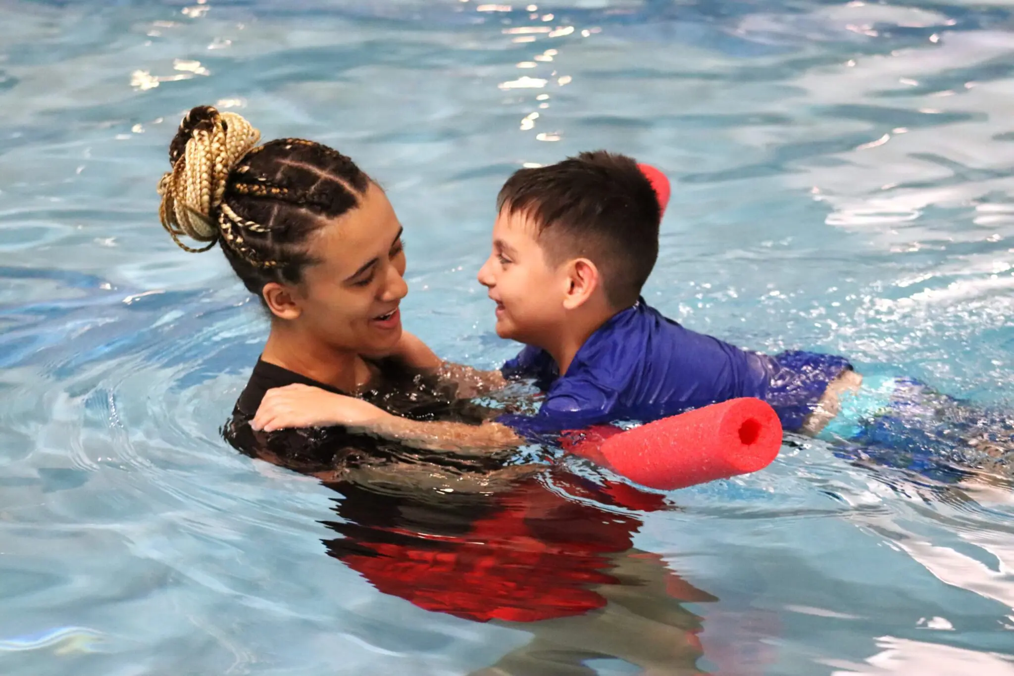 a person and a child in a pool