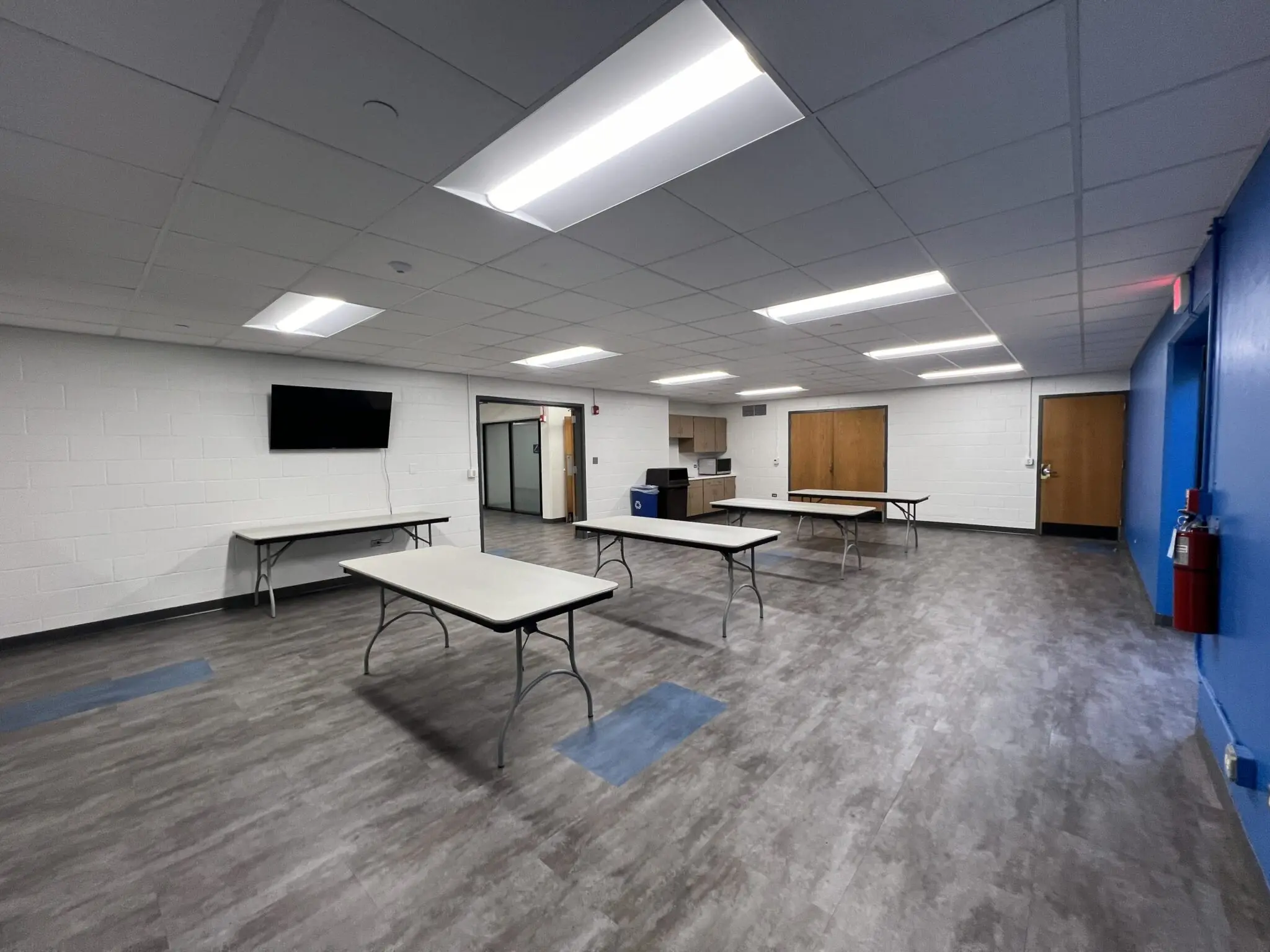 a room with tables and a television