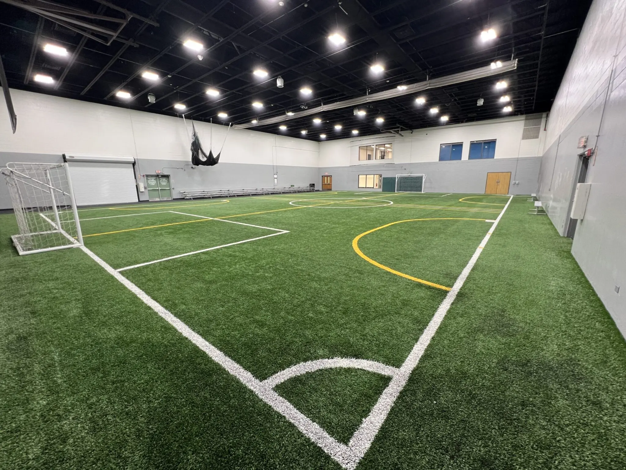 a indoor football field with white lines