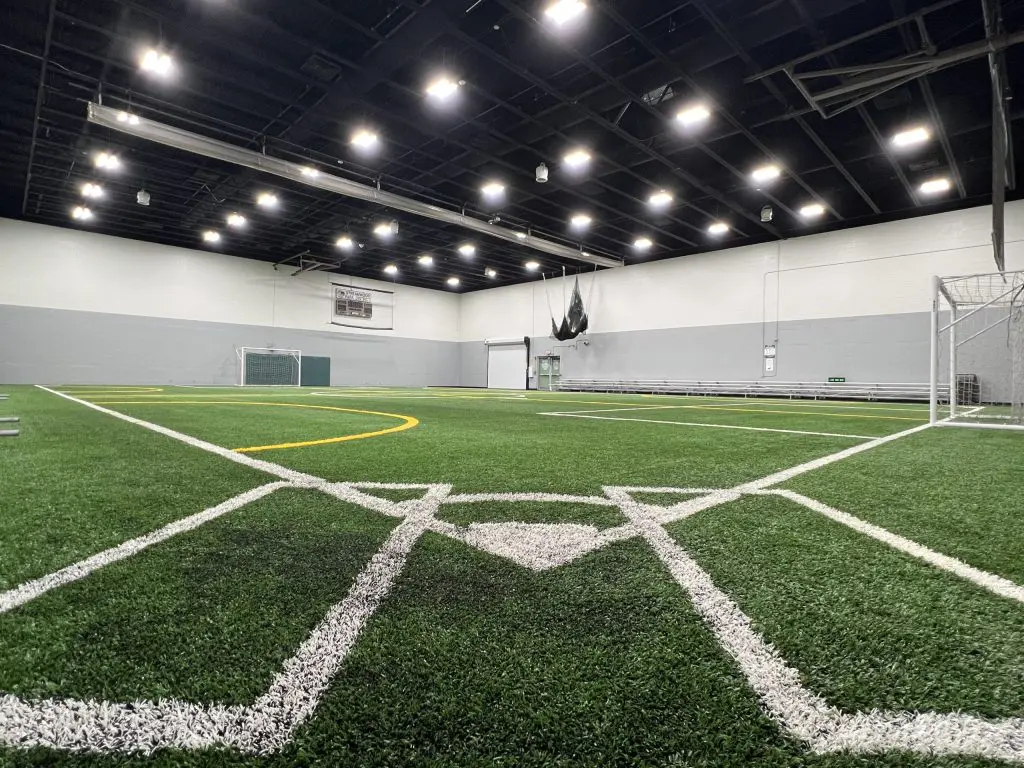 a indoor football field with white lines