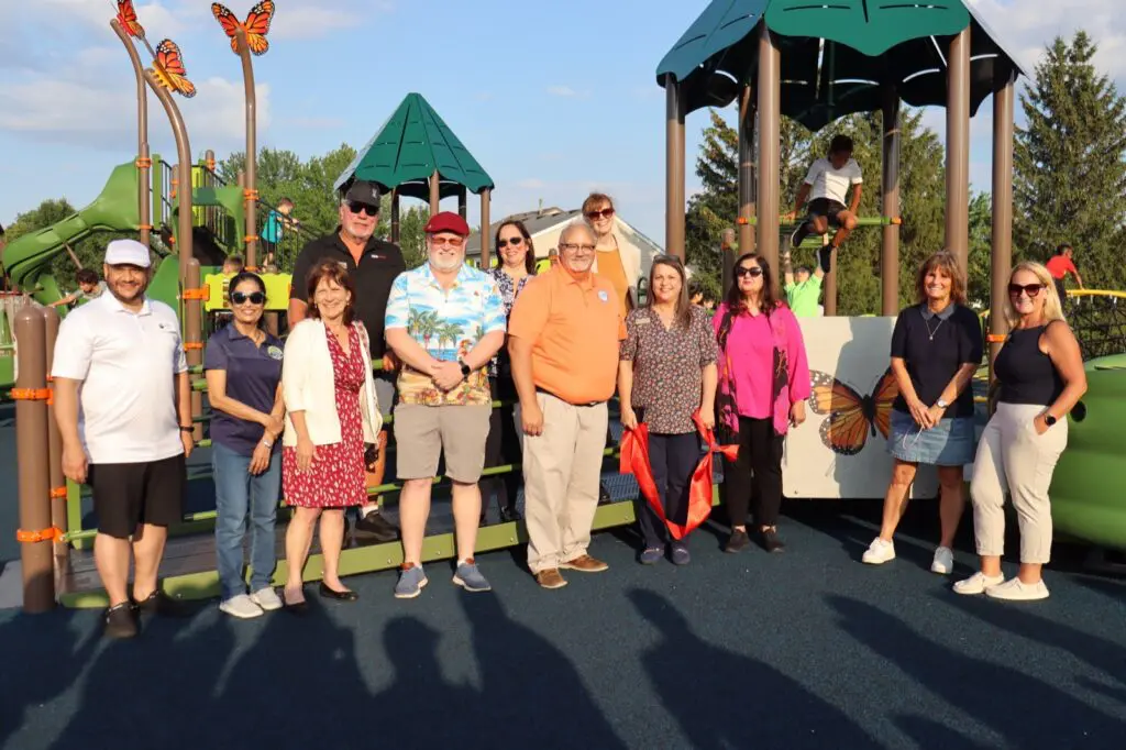 a group of people standing in front of a playground