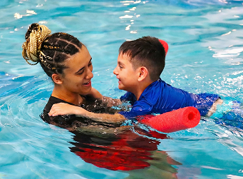 a person and a child in a pool