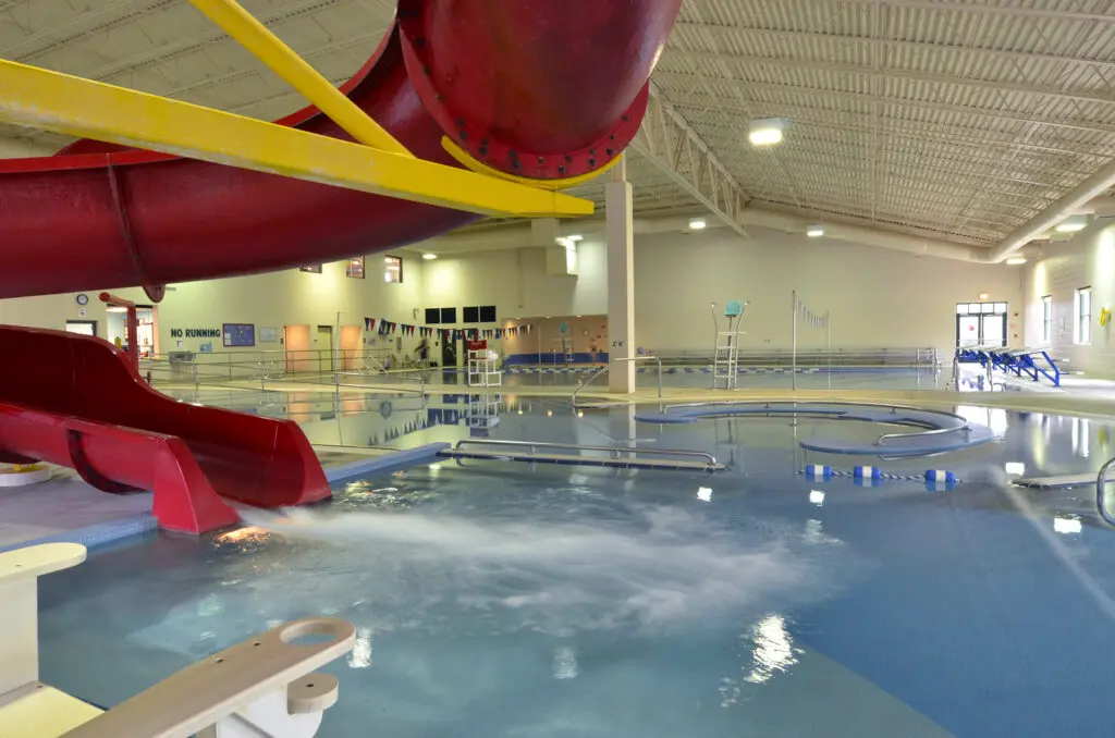 a large indoor swimming pool with a slide
