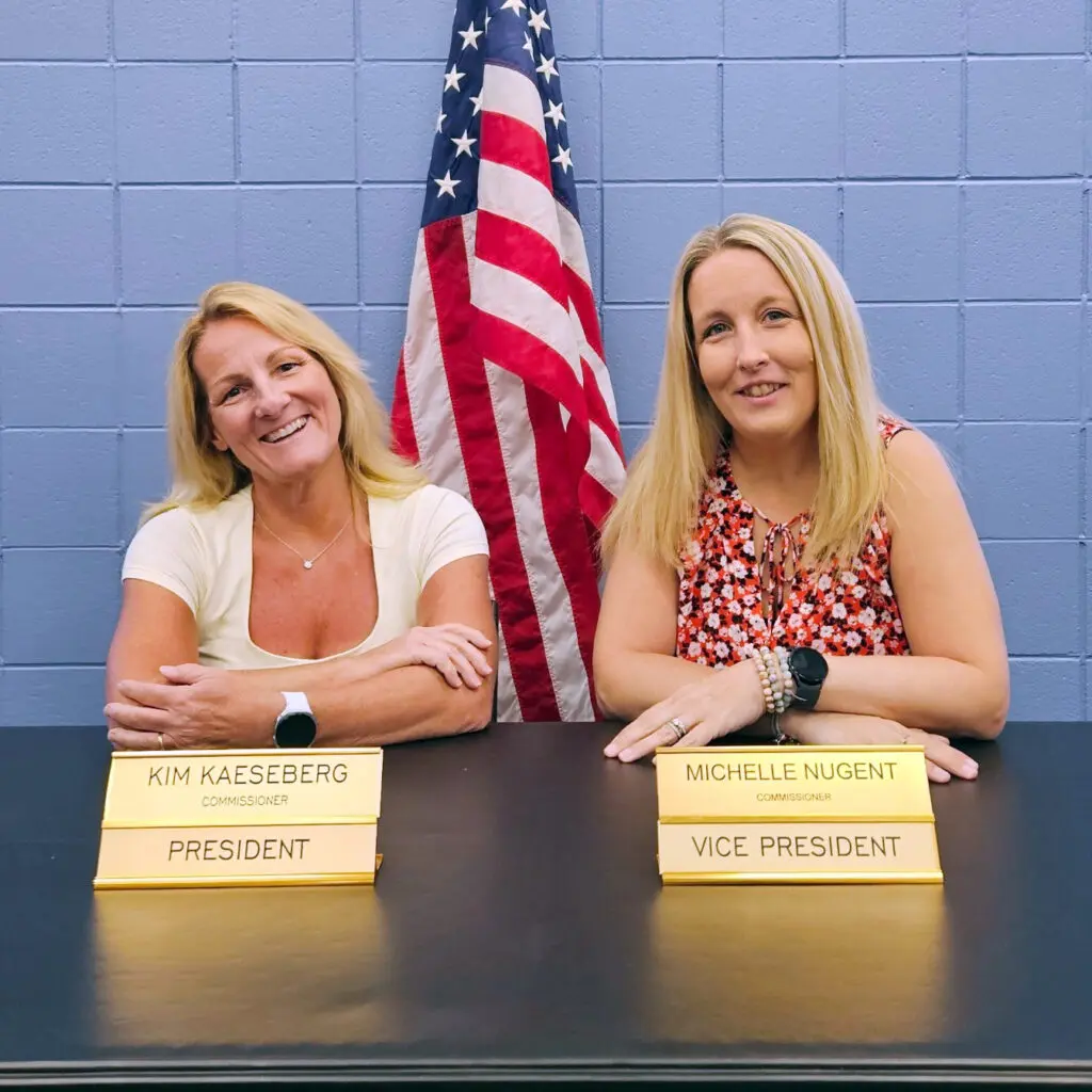 a group of women sitting at a table with name tags