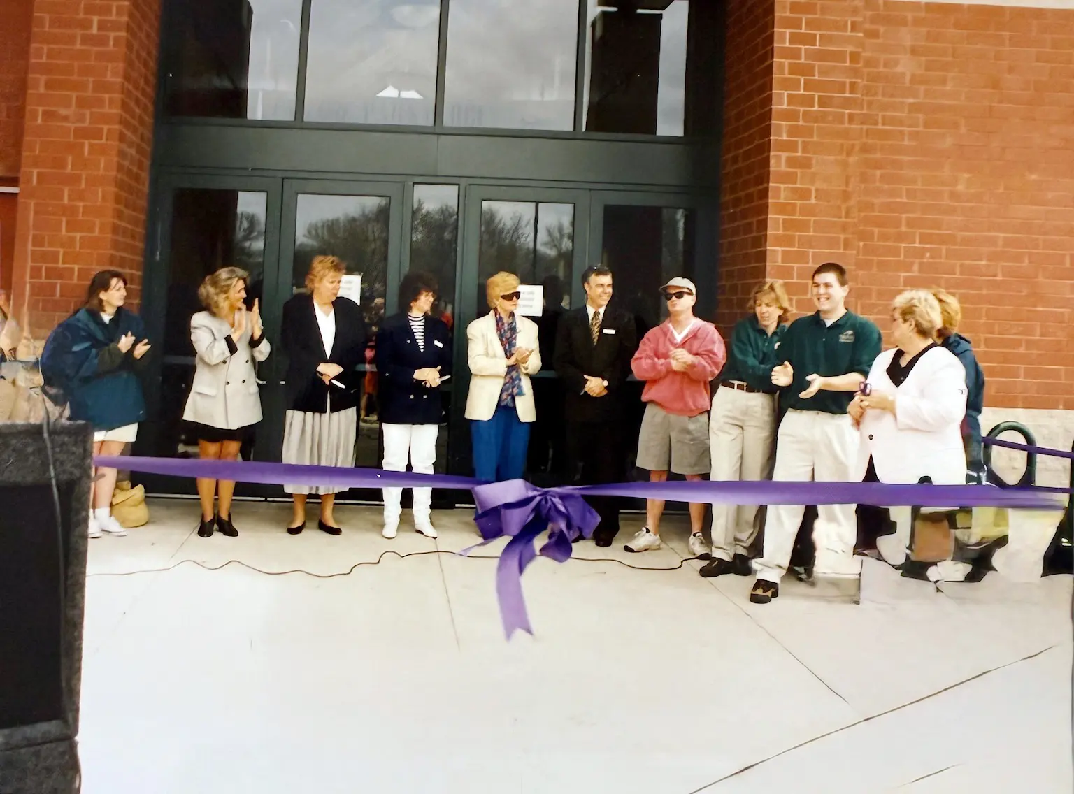 people cutting ribbon for grand opening