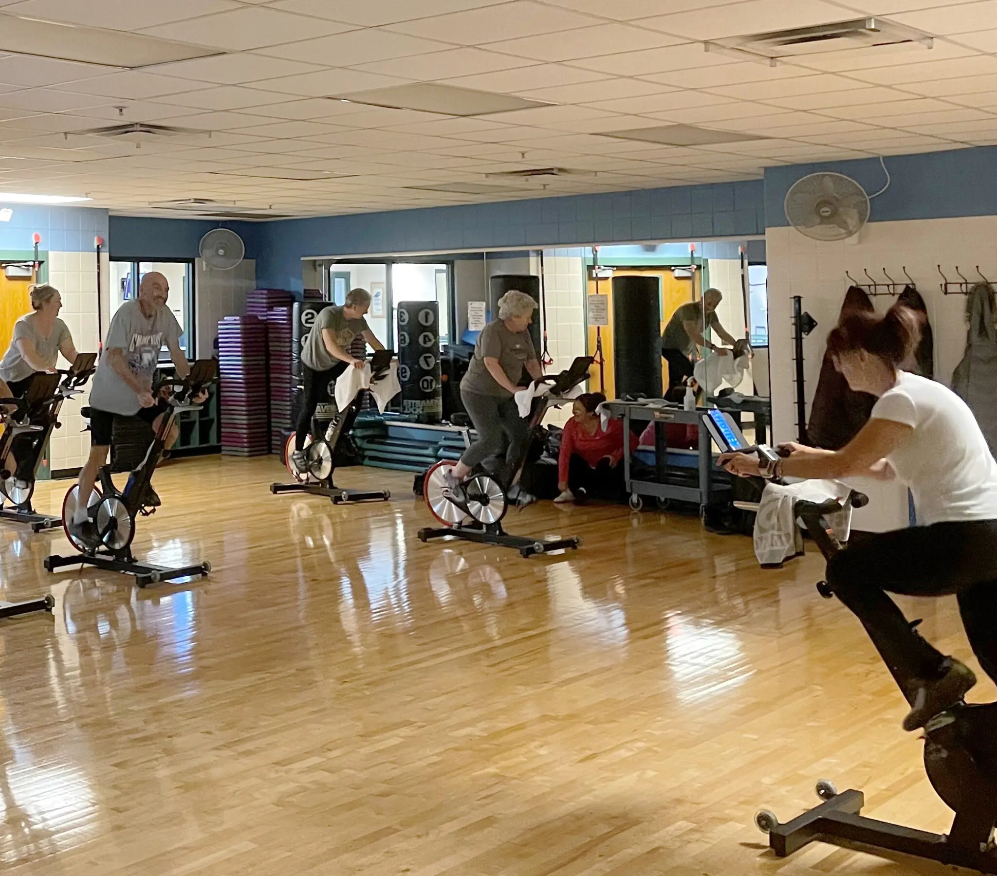 group of people on spin bikes inside a classroom