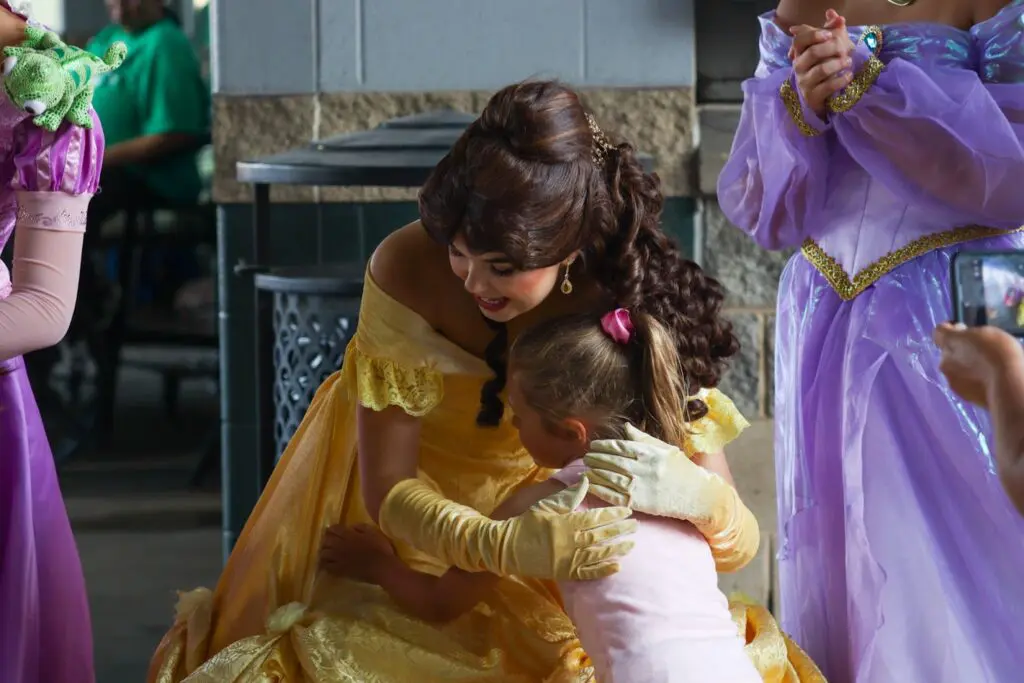 small girl hugging Princess Belle