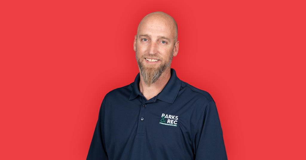 man with beard on a red background