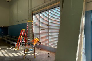 man and equipment installing louver wall