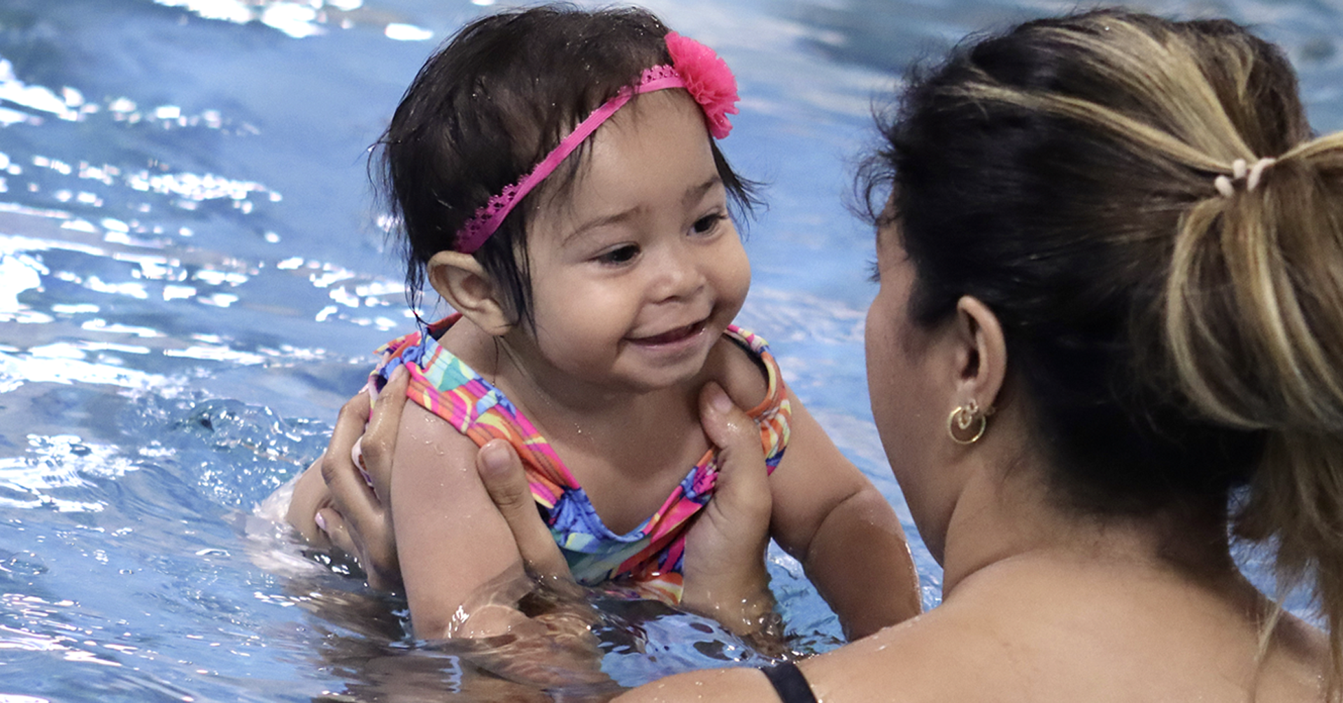 girl jumping in fallen leaves at a park